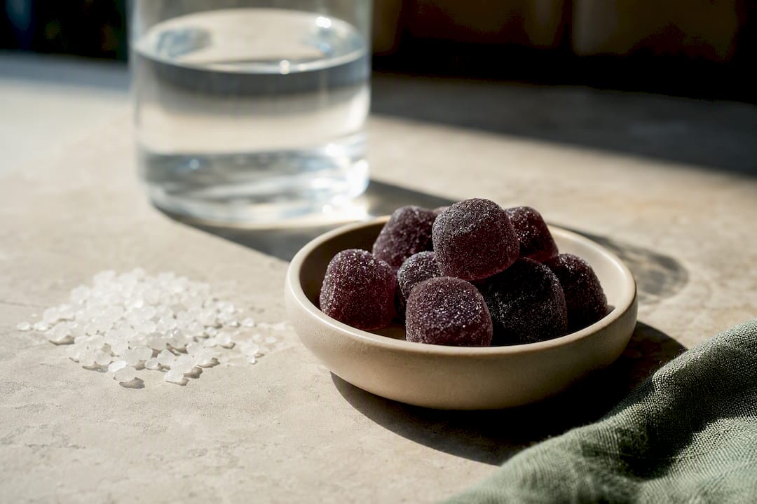 Anonymous magnesium gummies beside mineral granules